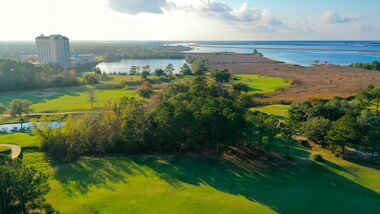view of golf course near water