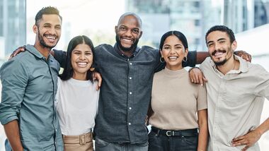 diverse group of team member posing for a group photo