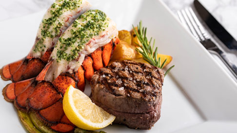 Twin Lobster Tails and Filet Mignon with potatoes and lemon