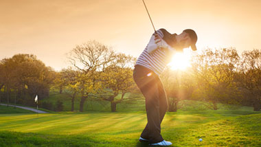 golfer teeing off